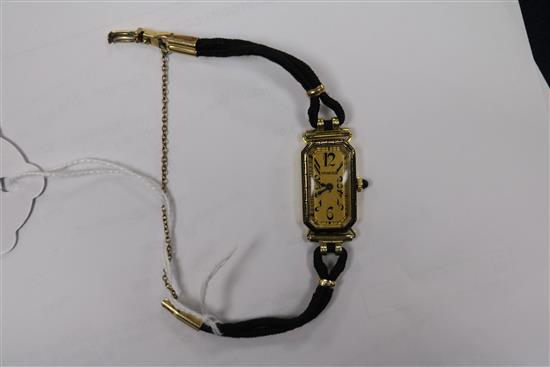 A ladys 18ct gold Longines manual wind wrist watch retailed by Tiffany & Co, on fabric strap.
